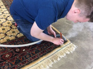 a worker providing Oriental Rug Cleaning in Monroe County, Pittsford, Fairport, Victor, NY, Brighton, NY, Rochester