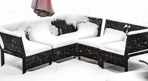 Snow on Outdoor Patio Couch Needing Upholstery Cleaning in Pittsford, NY