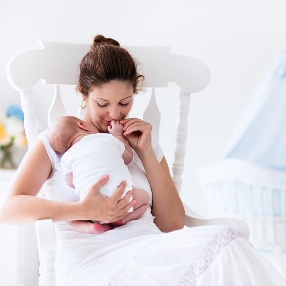 Newborn and Mom Sitting After Air Duct Cleaning in Pittsford, NY